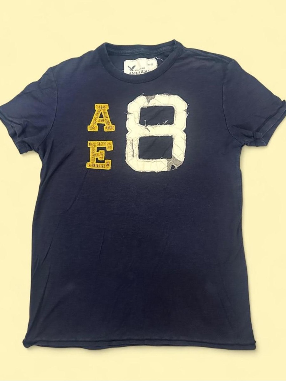 American Eagle Outfitters Navy Tee with White '8' and Yellow AE Patch